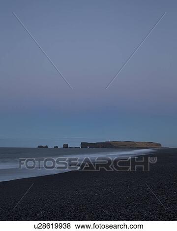 Sunrise over Dyrholaey rock arch formation, Iceland View Large Photo Image Stock Photo - Sunrise over Dyrholaey rock arch formation, Iceland. Fotosearch