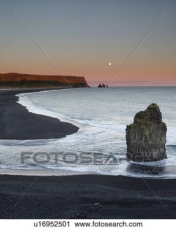 Sunset and moonrise over Dyrholaey sea stacks, Iceland View Large Photo Image Stock Image - Sunset and moonrise over Dyrholaey sea stacks, Iceland. Fotosearch