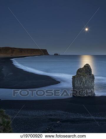 Sunset and moonrise over Dyrholaey sea stacks, Iceland View Large Photo Image Stock Image - Sunset and moonrise over Dyrholaey sea stacks, Iceland. Fotosearch