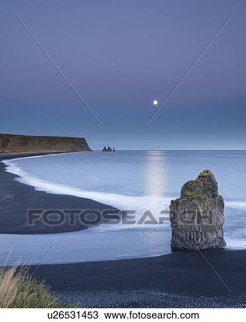Sunset and moonrise over Dyrholaey sea stacks, Iceland View Large Photo Image Stock Image - Sunset and moonrise over Dyrholaey sea stacks, Iceland. Fotosearch
