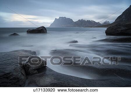Stock Image - Tidal pools and waves, Uttakveir at sunset, Norway. Fotosearch