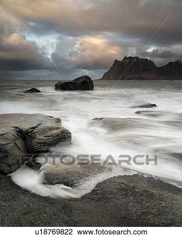 Stock Image - Tidal pools and waves, Uttakveir at sunset, Norway. Fotosearch