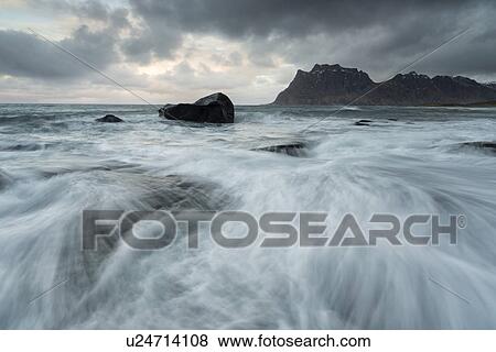 Stock Photo - Tidal pools and waves, Uttakveir at sunset, Norway. Fotosearch