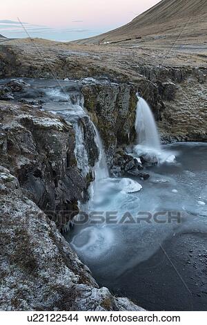 Picture - Waterfall at Grundarfjordur in winter, Snaefellnes, Iceland. Fotosearch