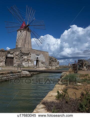 Stock Photography - Windmills at Trapani saline pans, Sicily, Italy. Fotosearch