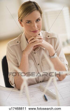 Stock Image - Architect working in firm dealing with wind power. Fotosearch