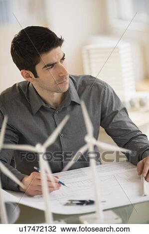 Architect working in firm dealing with wind power View Large Photo Image Stock Image - Architect working in firm dealing with wind power. Fotosearch