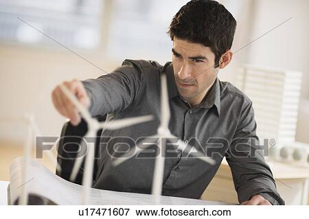 Architect working in firm dealing with wind power View Large Photo Image Stock Photo - Architect working in firm dealing with wind power. Fotosearch