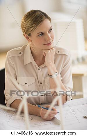 Stock Photograph - Architect working in firm dealing with wind power. Fotosearch