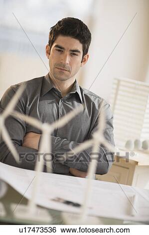Architect working in firm dealing with wind power View Large Photo Image Stock Photograph - Architect working in firm dealing with wind power. Fotosearch