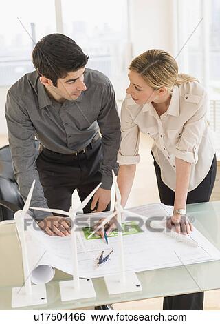Architects looking at scale models of wind turbines View Large Photo Image Stock Photograph - Architects looking at scale models of wind turbines. Fotosearch