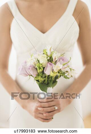 Bride holding bouquet View Large Photo Image Stock Image - Bride holding bouquet. Fotosearch