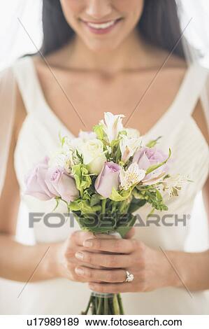 Bride holding bouquet View Large Photo Image Stock Photo - Bride holding bouquet. Fotosearch