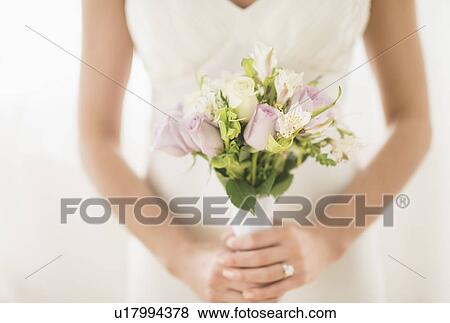 Bride holding bouquet View Large Photo Image Stock Photo - Bride holding bouquet. Fotosearch