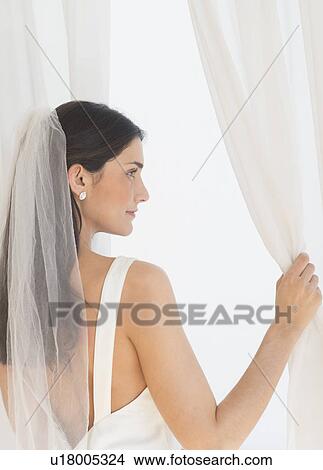 Bride looking through window View Large Photo Image Picture - Bride looking through window. Fotosearch