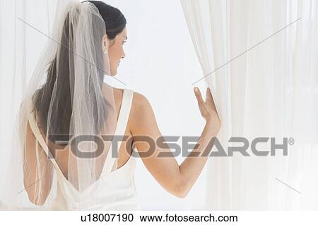 Bride looking through window View Large Photo Image Stock Image - Bride looking through window. Fotosearch