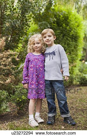Picture - Brother (6-7) and sister (4-5) posing together in garden . Fotosearch