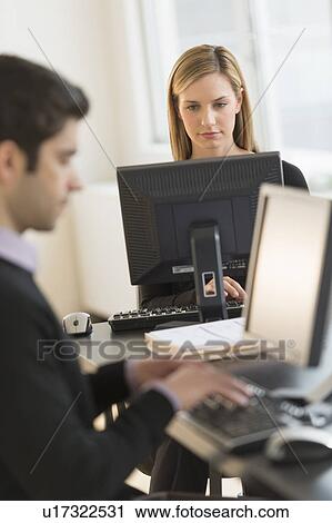 Business man and woman working in office View Large Photo Image Stock Image - Business man and woman working in office. Fotosearch