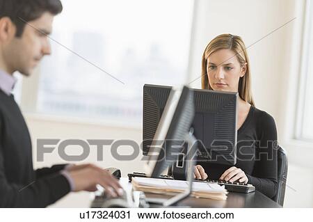 Business man and woman working in office View Large Photo Image Stock Image - Business man and woman working in office. Fotosearch