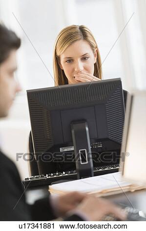 Business man and woman working in office View Large Photo Image Stock Image - Business man and woman working in office. Fotosearch
