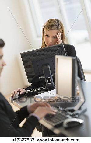 Business man and woman working in office View Large Photo Image Stock Photo - Business man and woman working in office. Fotosearch