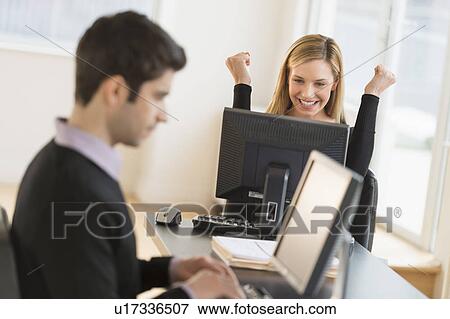 Business man and woman working in office View Large Photo Image Stock Photo - Business man and woman working in office. Fotosearch