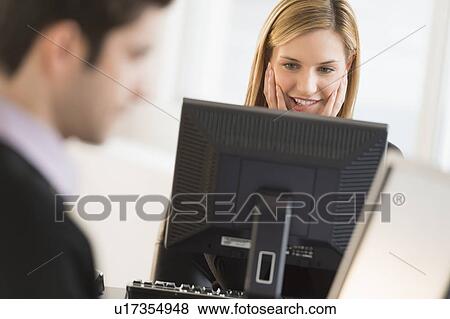 Business man and woman working in office View Large Photo Image Stock Photo - Business man and woman working in office. Fotosearch