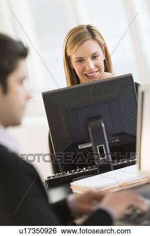 Business man and woman working in office View Large Photo Image Stock Photograph - Business man and woman working in office. Fotosearch