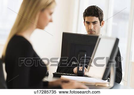 Business man and woman working in office View Large Photo Image Stock Photography - Business man and woman working in office. Fotosearch