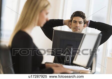 Business man and woman working in office View Large Photo Image Stock Photography - Business man and woman working in office. Fotosearch
