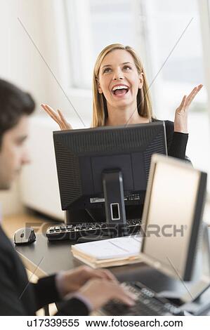 Stock Photography - Business man and woman working in office. Fotosearch
