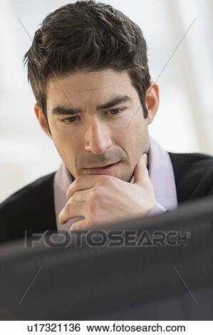 Business man looking at computer View Large Photo Image Stock Photograph - Business man looking at computer. Fotosearch