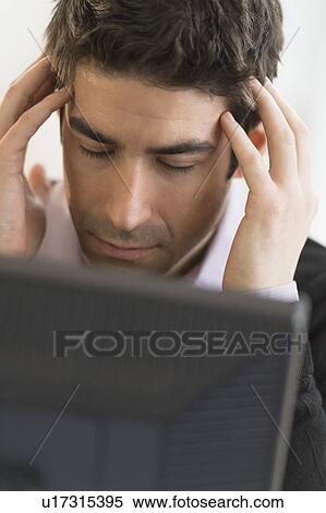 Stock Photography - Business man with head in hands. Fotosearch