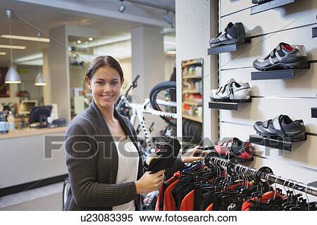 Business owner pricing sportswear in store View Large Photo Image Stock Photography - Business owner pricing sportswear in store. Fotosearch