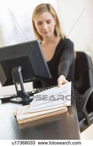 Stock Image - Business woman in office. Fotosearch
