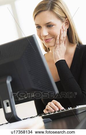 Business woman looking at computer View Large Photo Image Picture - Business woman looking at computer. Fotosearch