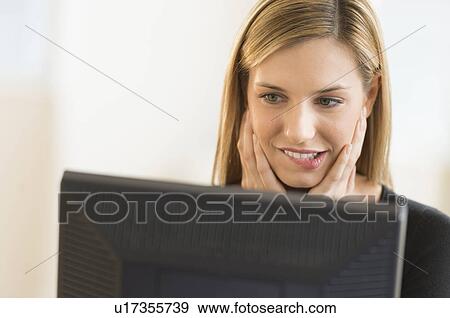 Stock Photo - Business woman looking at computer. Fotosearch