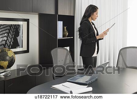 Businesswoman working in office View Large Photo Image Stock Photo - Businesswoman working in office. Fotosearch