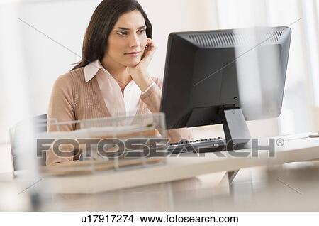 Businesswoman working on computer View Large Photo Image Picture - Businesswoman working on computer. Fotosearch
