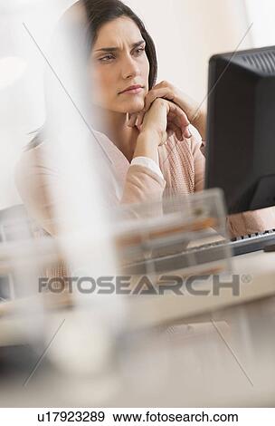 Stock Photo - Businesswoman working on computer. Fotosearch
