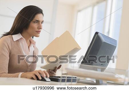 Businesswoman working on computer View Large Photo Image Stock Photograph - Businesswoman working on computer. Fotosearch