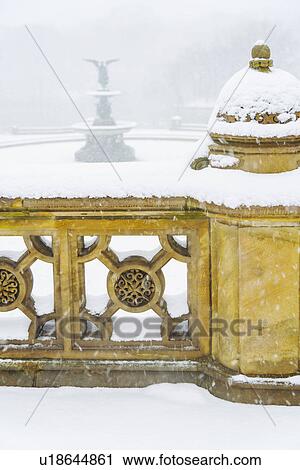 Stock Image - Central Park, Bethesda Fountain covered with snow in winter. Fotosearch