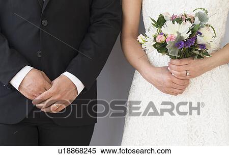 Close-up of bride and groom standing side by side View Large Photo Image Stock Photography - Close-up of bride and groom standing side by side. Fotosearch