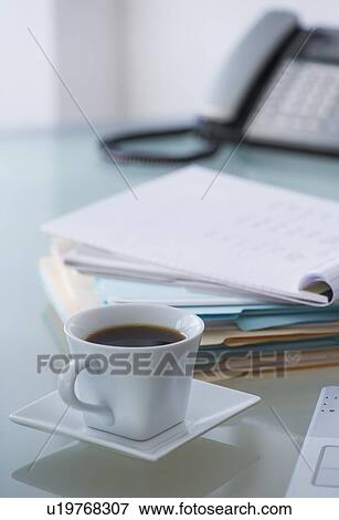 Close-up of coffee, paper material and telephone View Large Photo Image Stock Photo - Close-up of coffee, paper material and telephone. Fotosearch