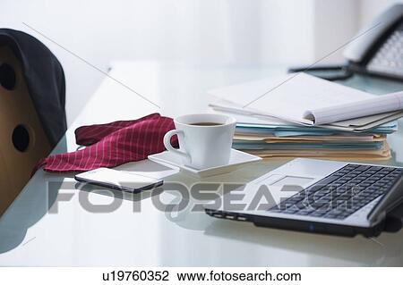 Close-up of coffee, paper material, tie, mobile phone and laptop View Large Photo Image Stock Image - Close-up of coffee, paper material, tie, mobile phone and laptop. Fotosearch