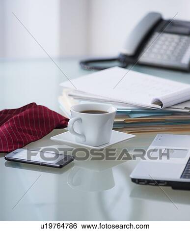 Close-up of coffee, paper material, tie, mobile phone and laptop View Large Photo Image Stock Photograph - Close-up of coffee, paper material, tie, mobile phone and laptop. Fotosearch