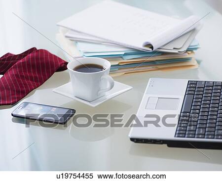 Stock Photography - Close-up of coffee, paper material, tie, mobile phone and laptop. Fotosearch