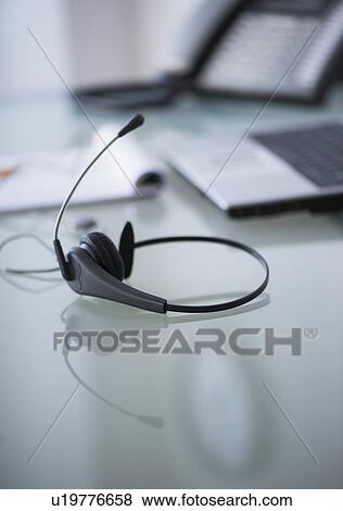 Close-up of headset on desk View Large Photo Image Stock Photo - Close-up of headset on desk. Fotosearch
