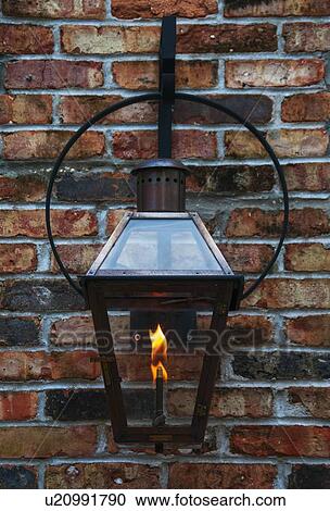 Close up of lantern hanging on brick wall View Large Photo Image Stock Image - Close up of lantern hanging on brick wall. Fotosearch