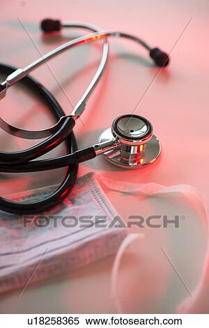 Stock Photography - Close up of stethoscope and surgical mask, studio shot. Fotosearch